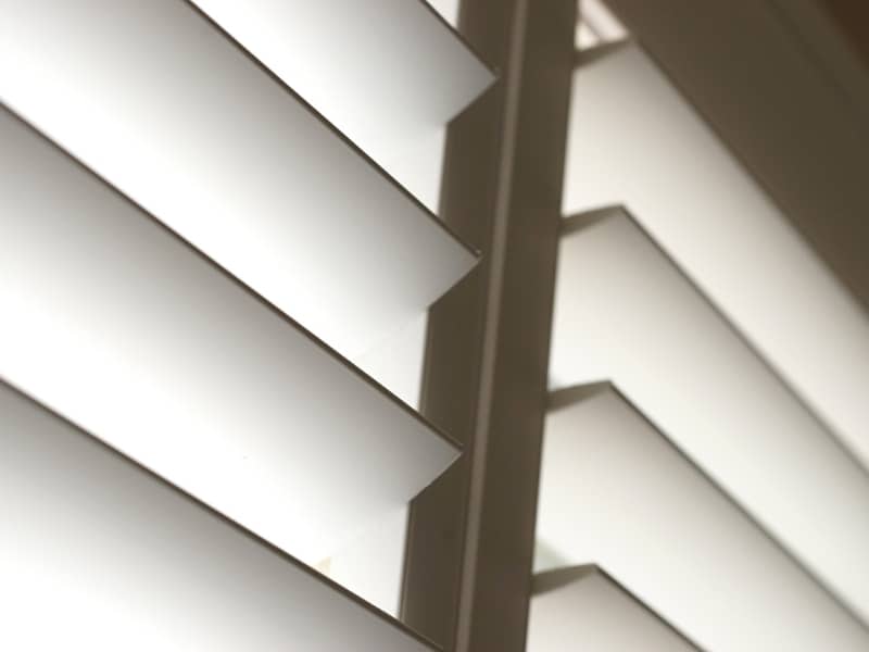 Close-up view of shutters on a window filtering natural light