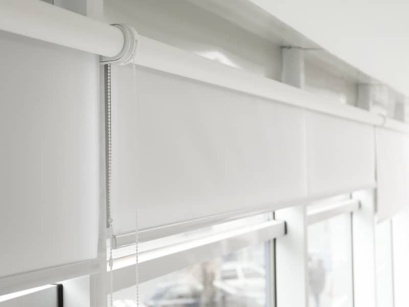 Mounted white roller blinds sizes fitted across modern window panels for uniform light control