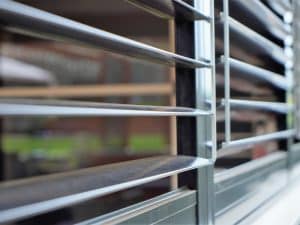 Close-up of aluminium louvres, showcasing energy-efficient design for window shutter replacement in modern homes.
